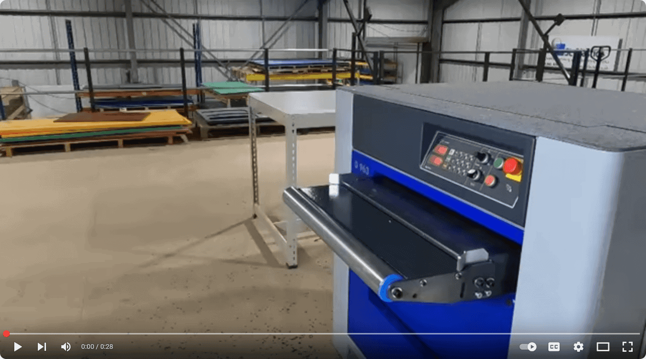Industrial plastic cutting machine with control panel and conveyor system.